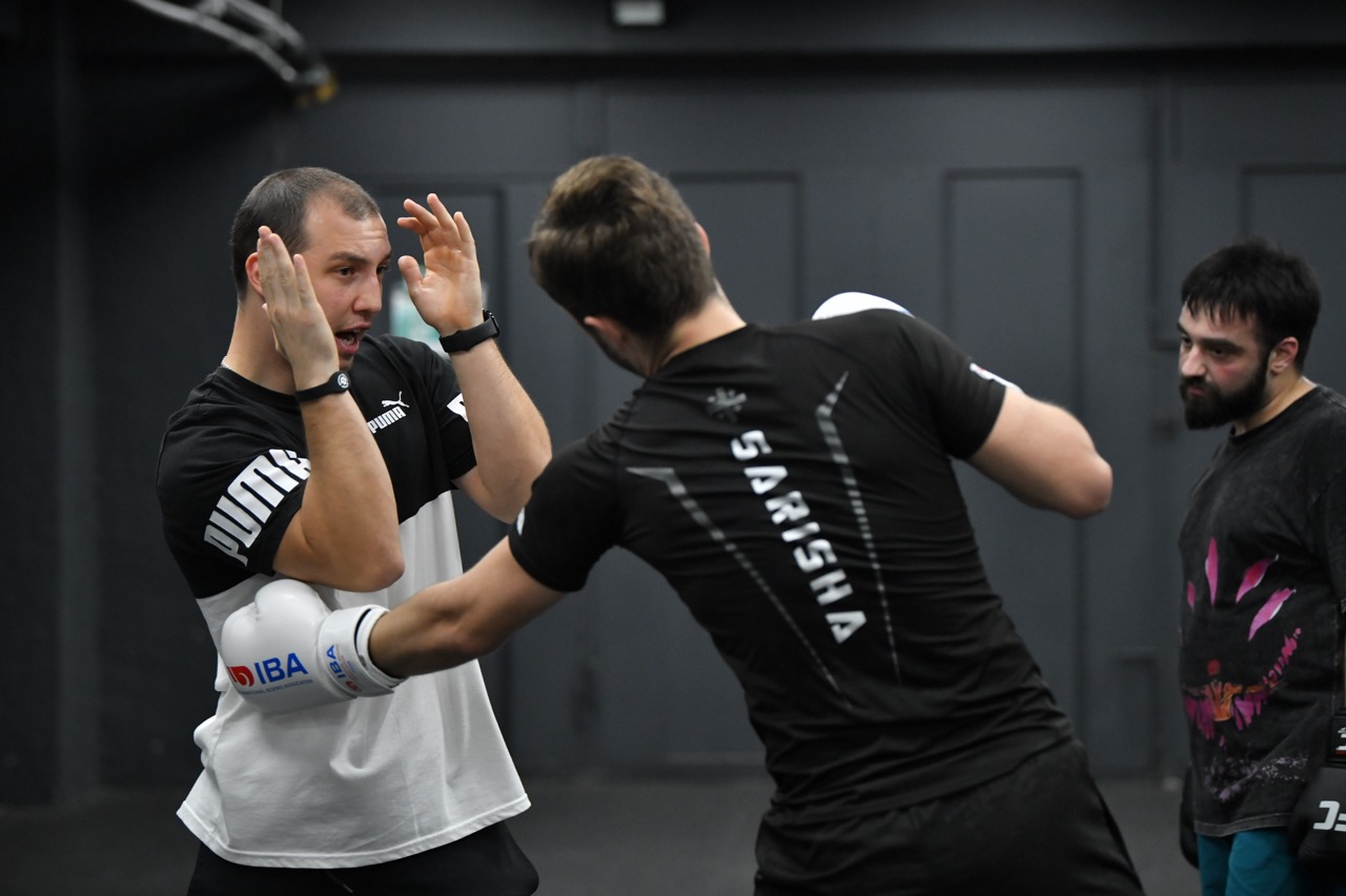 Boxing pad work with camp coaches