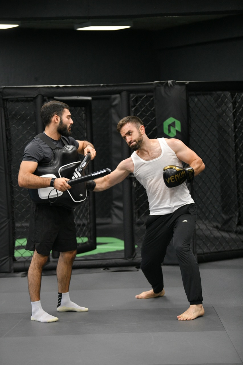 Athletes working striking combinations on pads